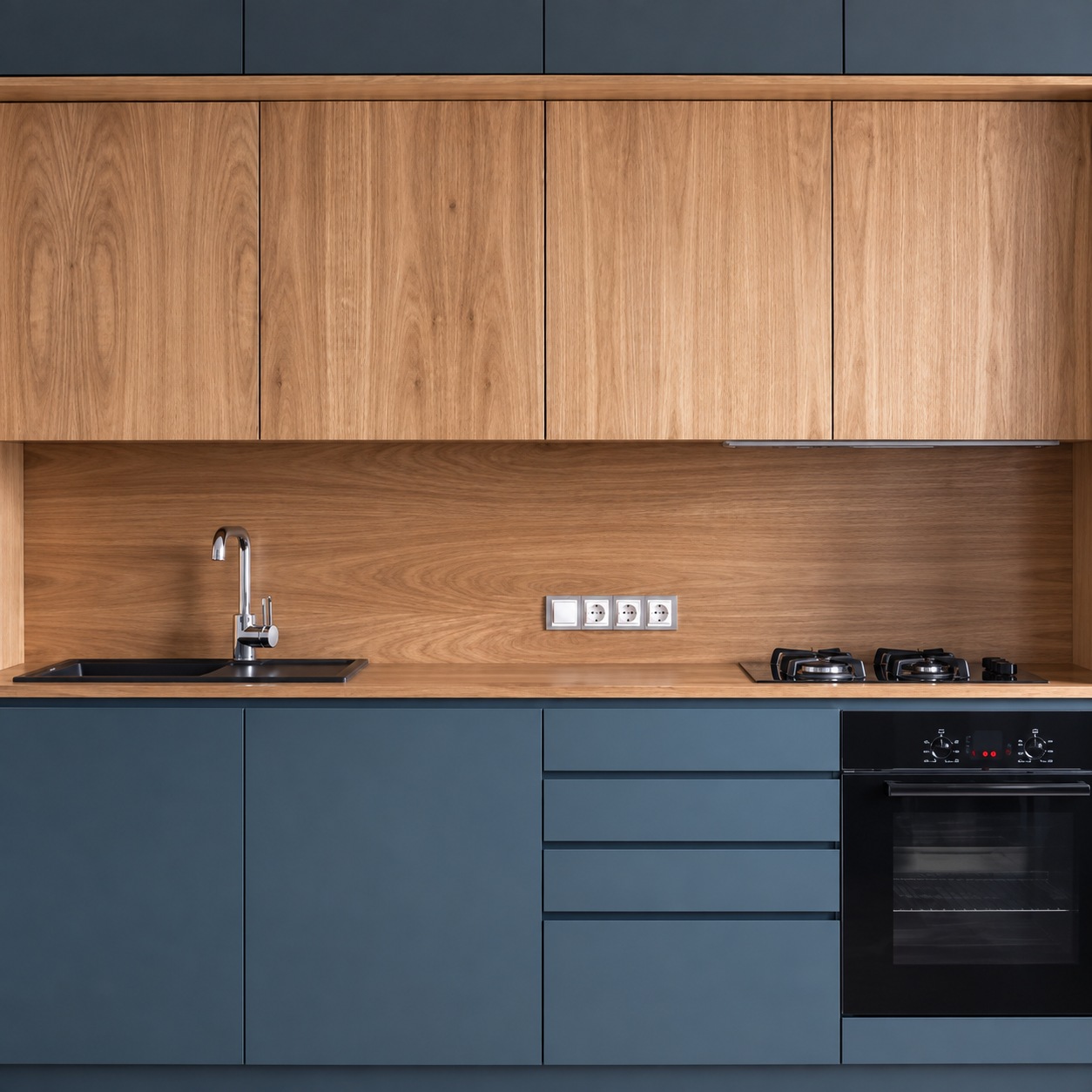 Cocina con alacenas y revestimiento de madera, muebles inferiores grafito y mesada oscura